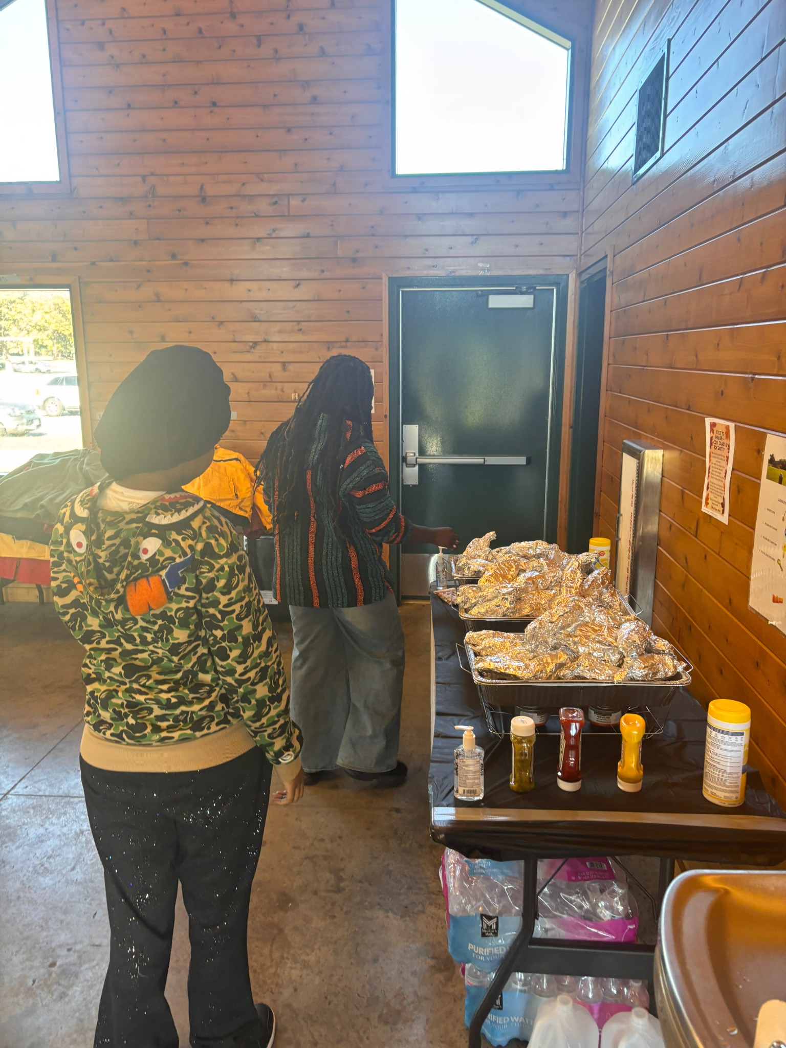 Community members approaching a food table at an event